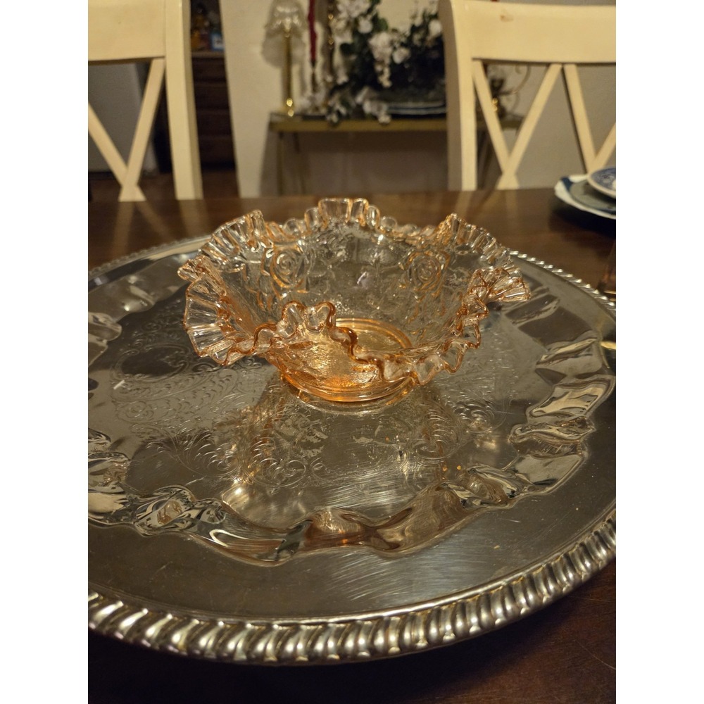 vintage pink Depression-era glass candy dish featuring a ruffled edge and a...